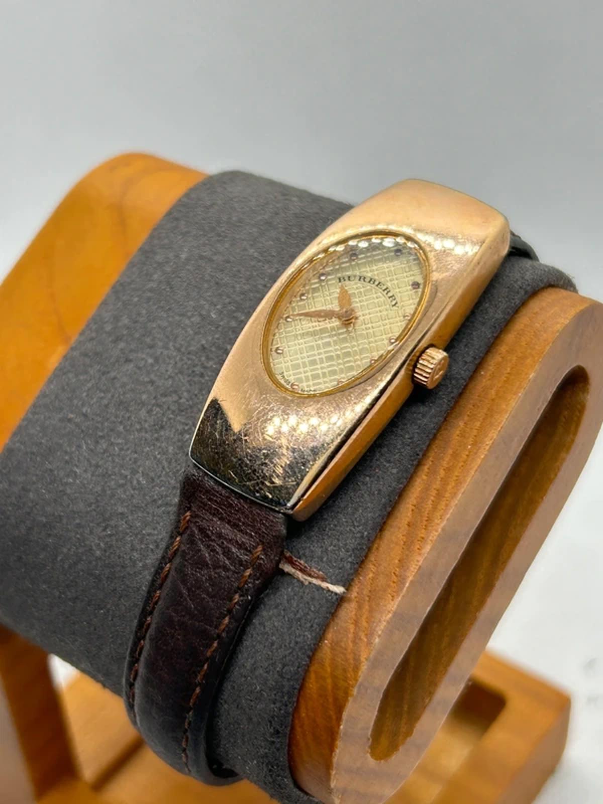 Ladies Burberry watch rose gold case with pattern dial and broken brown strap