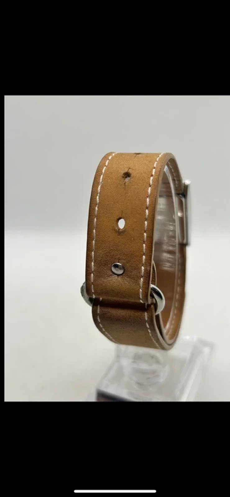 Ladies Lacoste silver case white dial watch with tan suede strap