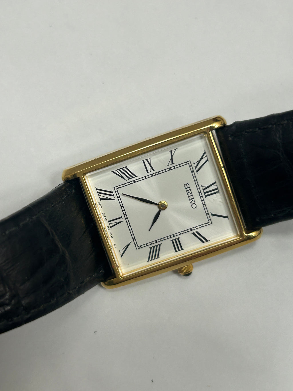 Vintage Seiko gold case tank watch white dial black strap