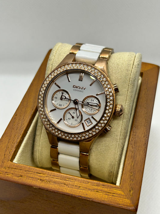 DKNY Ladies quartz watch rose gold and white with “diamond” features and date function