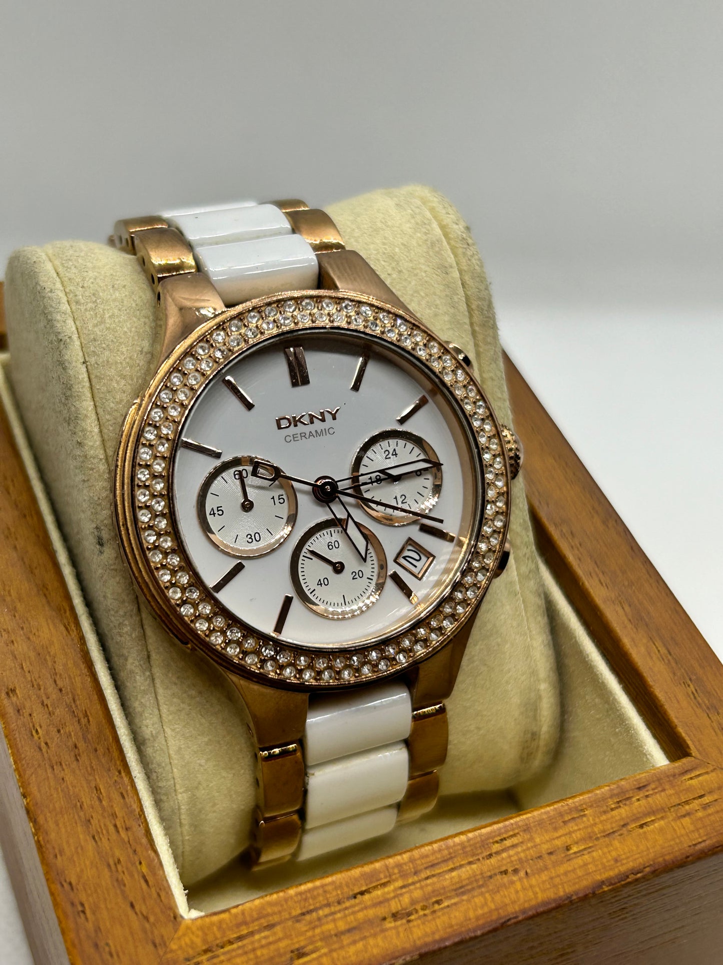 DKNY Ladies quartz watch rose gold and white with “diamond” features and date function