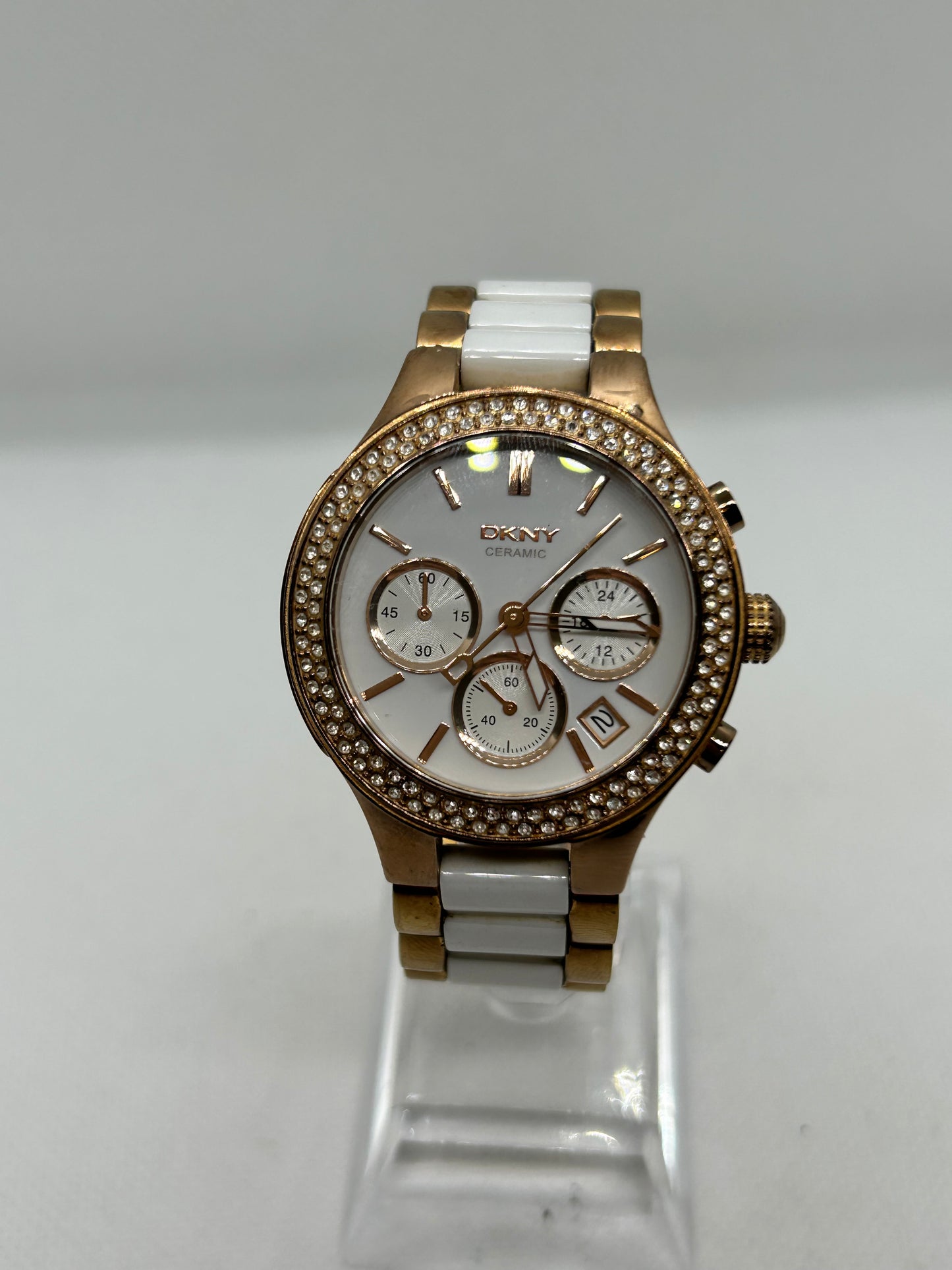 DKNY Ladies quartz watch rose gold and white with “diamond” features and date function