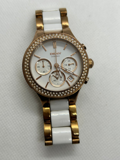 DKNY Ladies quartz watch rose gold and white with “diamond” features and date function