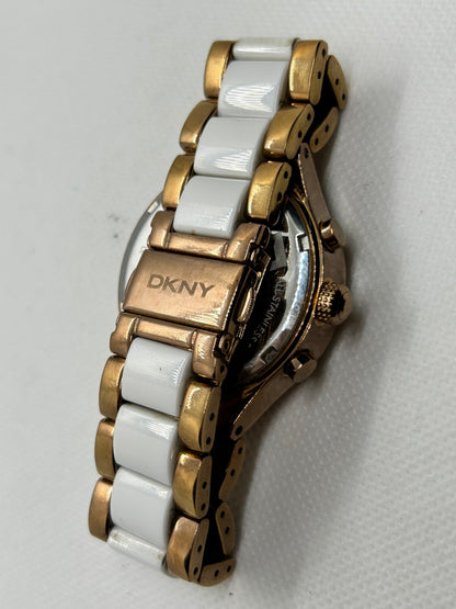 DKNY Ladies quartz watch rose gold and white with “diamond” features and date function