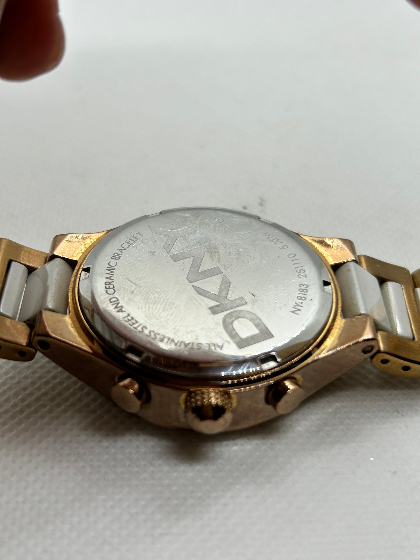 DKNY Ladies quartz watch rose gold and white with “diamond” features and date function