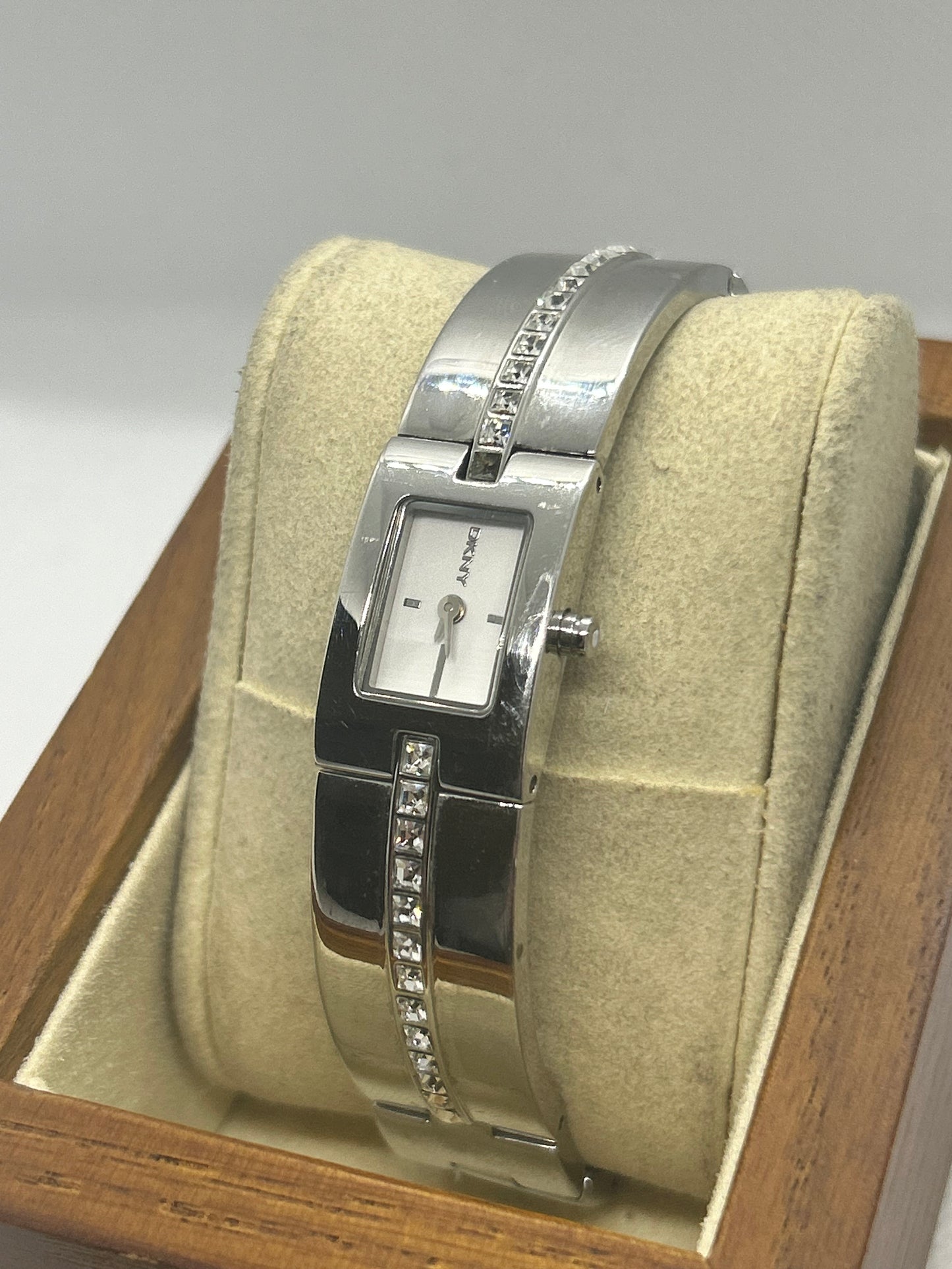 DKNY silver quartz bangle watch with “diamond” style bangle