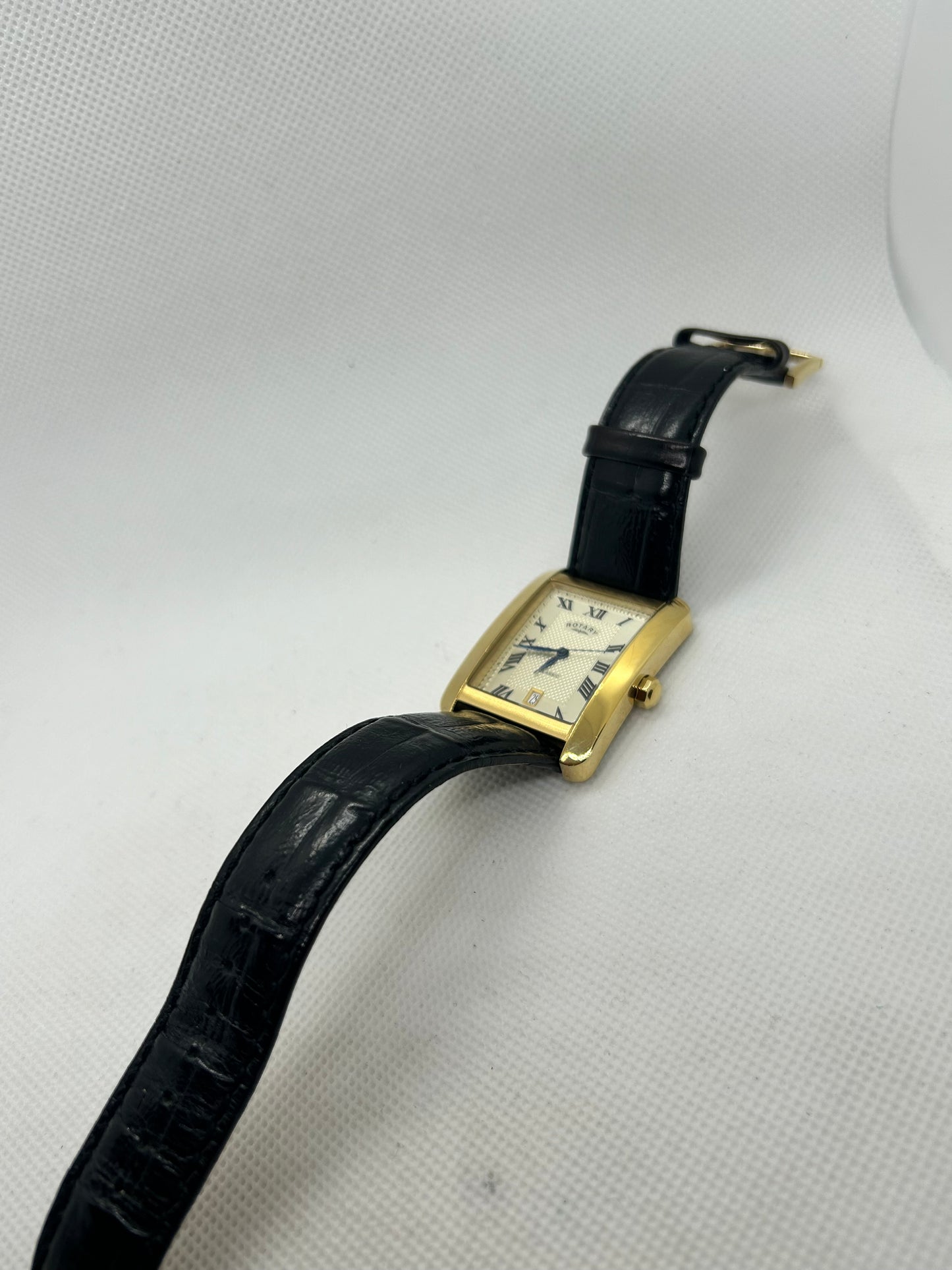 Rotary men’s quartz tank watch gold case with date function and black strap, with box