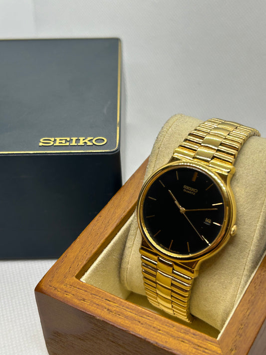 Seiko dress watch quartz gold watch with black dial and date function, with box