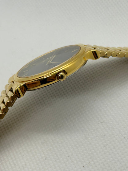 Seiko dress watch quartz gold watch with black dial and date function, with box