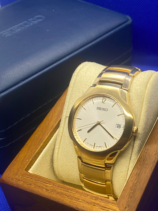 Seiko sports gold bracelet and dial with date function