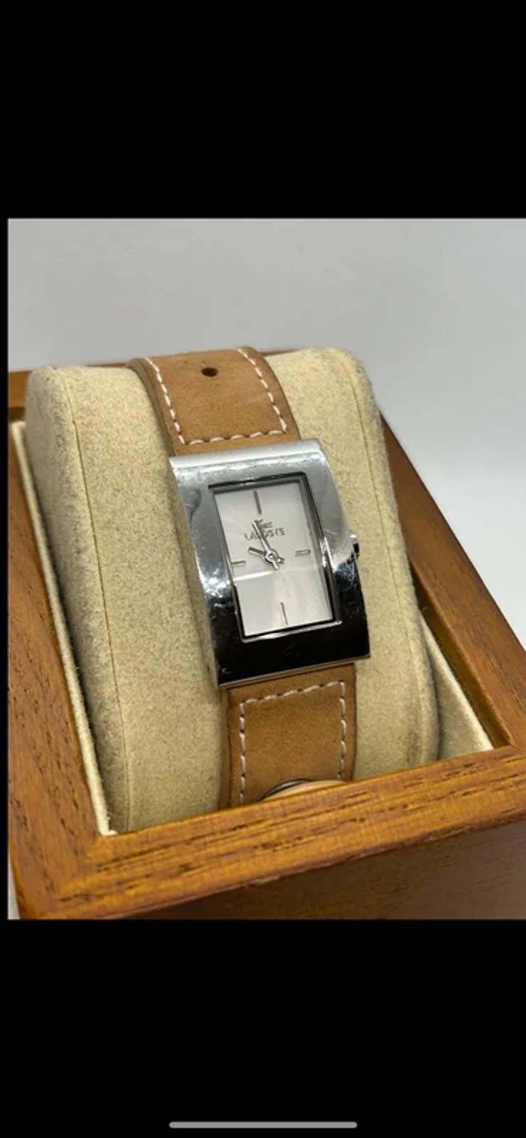 Ladies Lacoste silver case white dial watch with tan suede strap