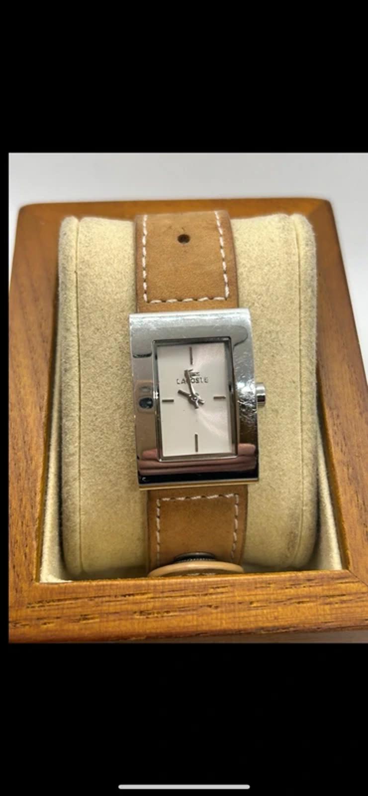 Ladies Lacoste silver case white dial watch with tan suede strap